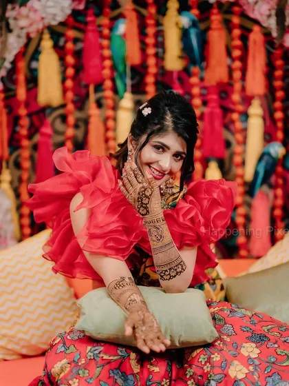 A beautiful shot of the bride showing off her intricate mehendi. Our vibrant decor, with its mix of textures and bright colors, provided the perfect backdrop for her photos.