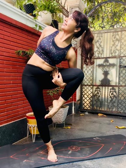 A standing balance pose that requires core strength and focus. This is a celebration of what the body can do, reminding us that happiness begins with movement and a strong body that carries us with grace.