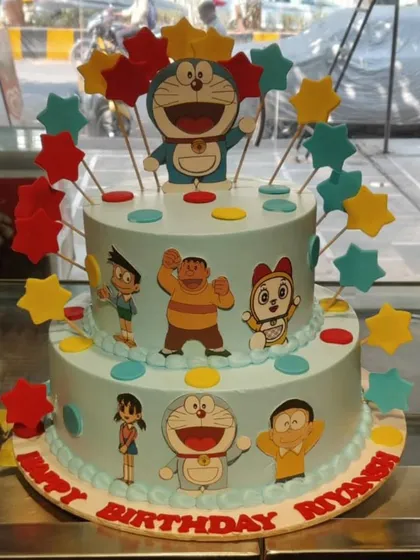 A colorful two-tier Doraemon cake, bringing the beloved anime character and his friends to life. Decorated with stars and bright colors, it's a fantastic centerpiece for a fan's birthday party.