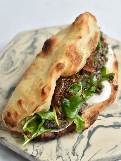 Our Mushroom Duxelles Sourdough Pizza Sandwich. This vegetarian option features a rich mushroom and truffle oil filling with sweet caramelised onions and fresh mozzarella on our sourdough flatbread.