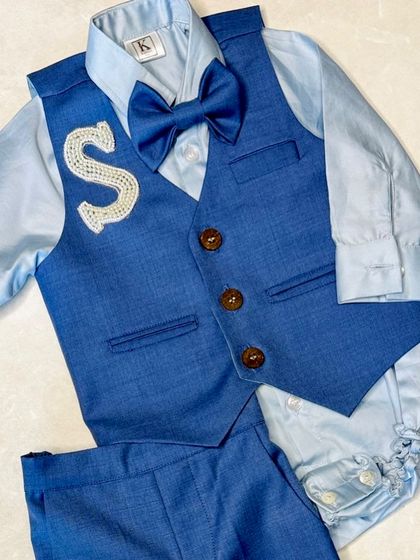 Dapper little dude alert. This navy suit set is personalized with a hand-embroidered initial 'S' and comes with a satin shirt and matching bowtie for a sharp, formal look.