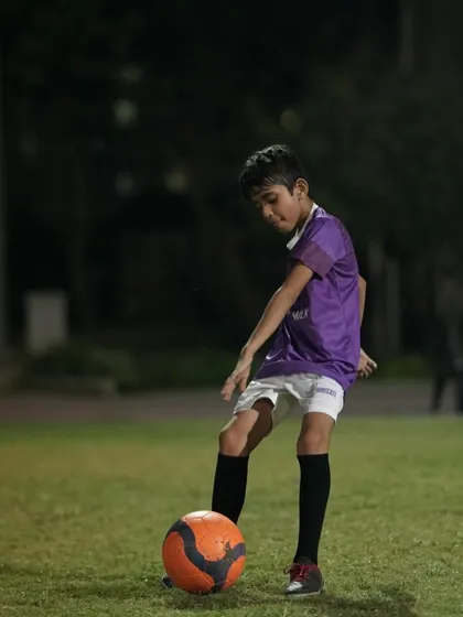 A young player practices his first touch. We emphasize the importance of ball mastery from the earliest age.