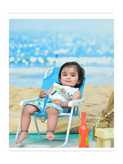 A sweet smile from the baby boy as he sits in his beach chair. The simple, bright setup keeps all the attention on his adorable face and happy mood.
