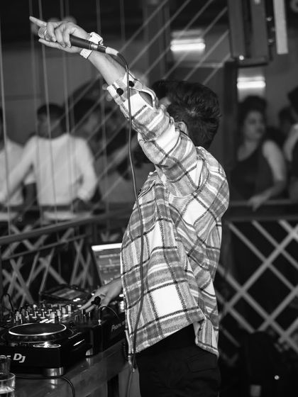 Getting the crowd hyped for New Year's Eve. A black and white shot capturing the raw energy and anticipation before the big moment.