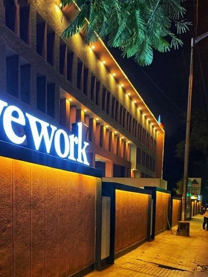 The WeWork building in Ashok Nagar after our facade reconstruction, illuminated at night. The new design gives the building a modern and professional identity.