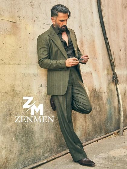 Channeling an old-money vibe with this custom green pinstripe suit. The relaxed fit and classic pattern offer a look of understated luxury and confidence.