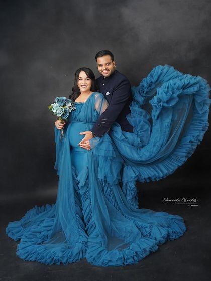 A dynamic and romantic shot. The flowing blue gown creates a beautiful sense of motion around the couple, adding a touch of magic to the portrait.