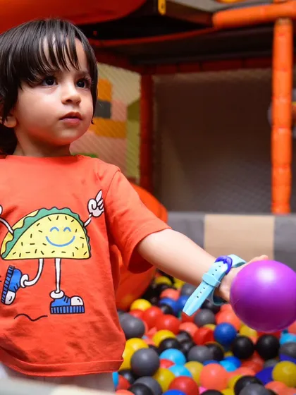 A focused look from a little one in the ball pit, ready for the next adventure.