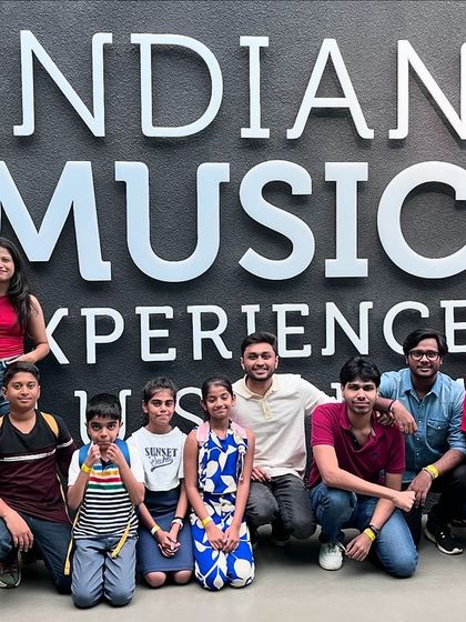 Our community of students and teachers gathered at the entrance of the Indian Music Experience museum, celebrating a shared love for music.