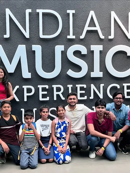 Posing in front of the Indian Music Experience entrance. We're grateful for insightful tours that enrich our students' understanding and appreciation of music.