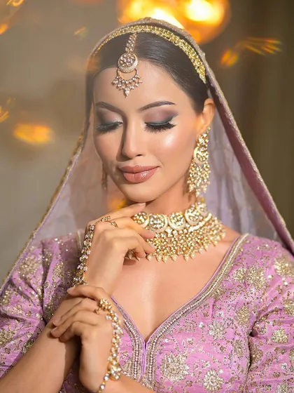 A dewy finish paired with a kohl-rimmed eye. This combination gives the bride a fresh, radiant glow while maintaining a touch of traditional drama.