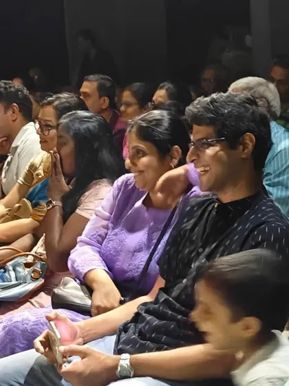 Happy parents and family members fill the audience, their faces reflecting the joy of watching their children perform on stage.