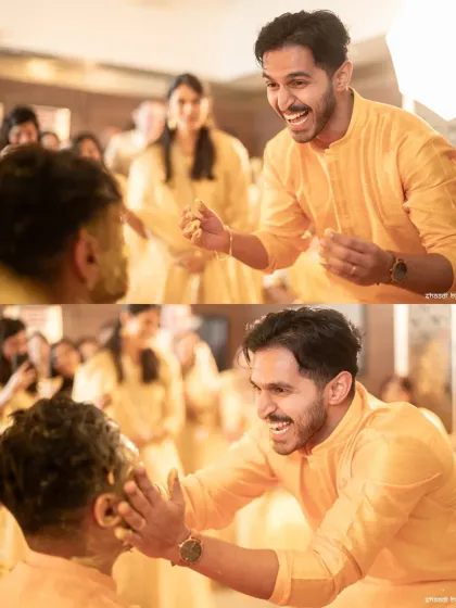 A friend's gleeful expression as he applies haldi to the groom. The joy is palpable.