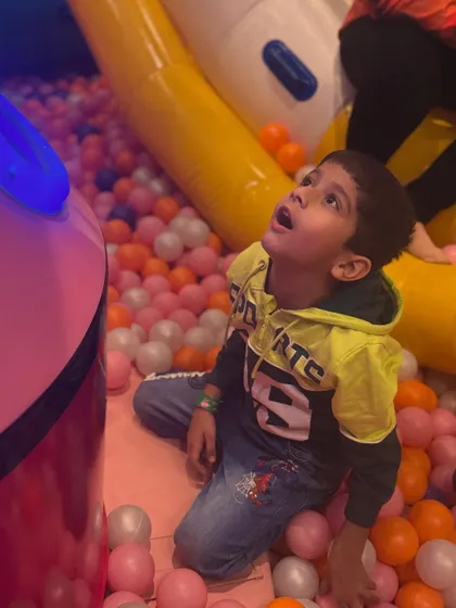 A moment of wonder in the ball pit. There's always something exciting to look at, from the interactive screens to the colorful surroundings.