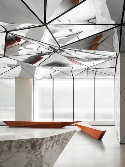 The corner of the reception desk highlights the precision of the stonework and its angular relationship with the rest of the space. Every detail is considered to reinforce the overall design concept.