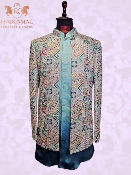 This Indo-Western set features a jacket with vibrant, multi-colored geometric embroidery, paired with a two-tone blue kurta. It's a majestic and modern look for any celebration.