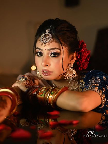 A close-up portrait that captures the bride's striking eyes and the intricate details of her look.