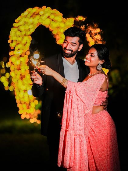 A duplicate of the magical night-time shot with sparklers and a heart-shaped arch of lights.