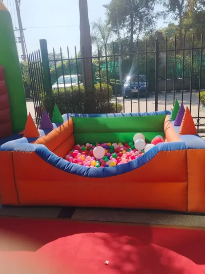 A full view of the empty ball pool, highlighting its bright colors and design before the kids jump in.