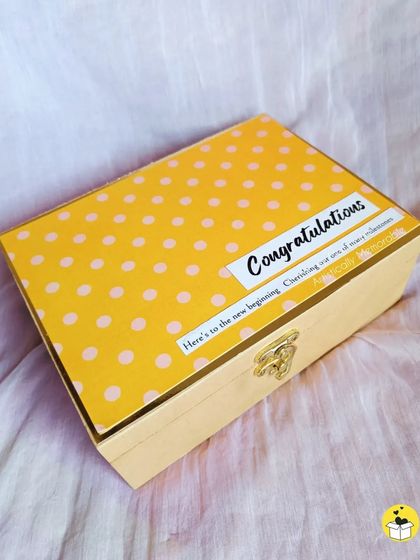 The cheerful yellow polka dot box used for the "Congratulations" hamper, celebrating a new beginning and many more milestones to come.