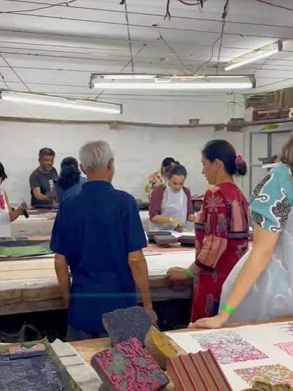 The studio buzzes with creative energy during a workshop. Participants learn side-by-side with our artisans, exploring our vast collection of blocks and creating their own unique designs on tote bags.