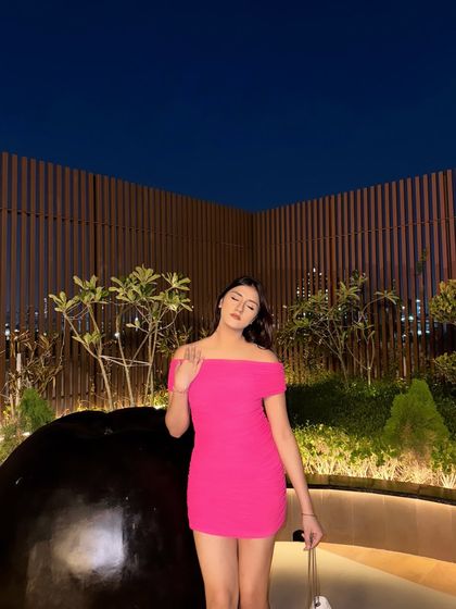 A candid, eyes-closed moment in the pink dress.