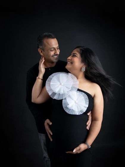 A joyful and intimate moment between a couple. The wind in her hair and their happy expressions make this a lively and beautiful maternity portrait.