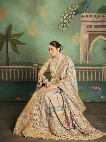 This custom Abu Jani Sandeep Khosla lehenga is fit for royalty. The rich gold detailing, vibrant colors, and traditional motifs create a heritage look that is both radiant and regal, ideal for a grand wedding ceremony.