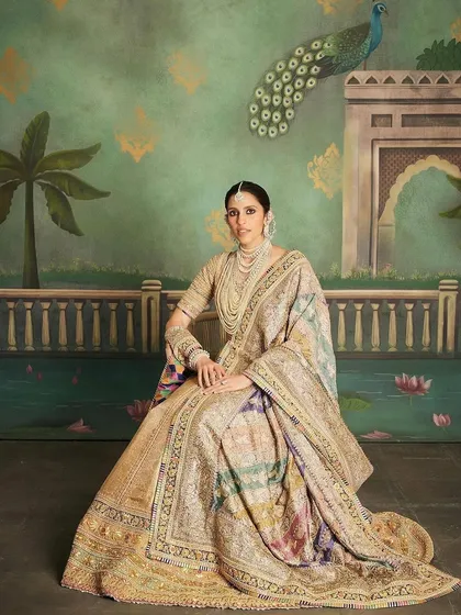 Seated portrait in the custom Abu Jani Sandeep Khosla lehenga, highlighting the incredible craftsmanship and the royal vibe of the entire ensemble.