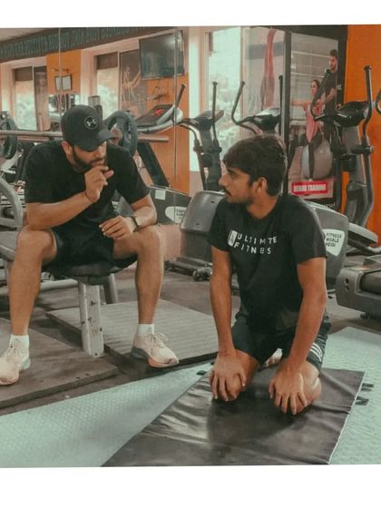 Fine-tuning the details. A post-exercise discussion with an athlete on a mat, breaking down the movement and talking about how it felt. This feedback loop is vital for learning.