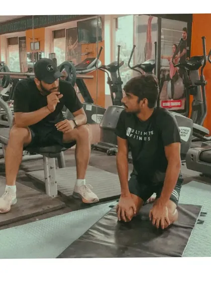 The conversation is as important as the exercise. I'm discussing the sensations the athlete is feeling during a corrective drill, ensuring we are fine-tuning the movement to achieve the desired neurological and fascial response.