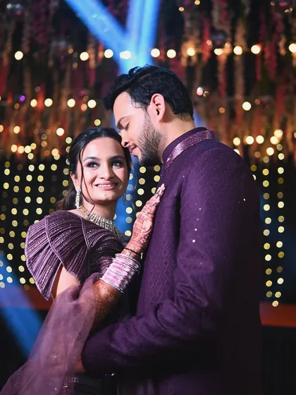 A romantic portrait of a couple at their reception. The warm bokeh of the background lights adds a magical feel to this intimate moment.