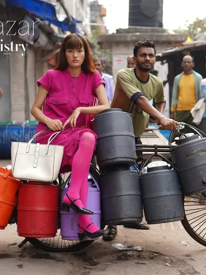 The Decker Shoulder Bag in classic white, seen here in the vibrant chaos of an Indian market. A structured and elegant tote for any setting.