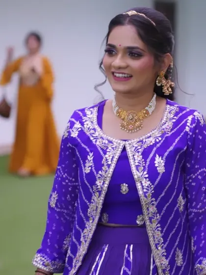 A candid moment from the event. The bride's makeup looks flawless even in natural outdoor lighting, perfect for daytime functions.