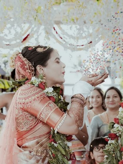 The 'jeerige bella' ritual, a playful and significant part of many South Indian weddings. I capture the laughter and tradition as the couple showers each other with a mix of cumin and jaggery.
