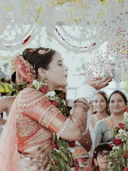 The bride's turn to shower the groom with rice. This action shot captures the fun and reciprocity of the talambralu ritual, with family looking on with smiles.