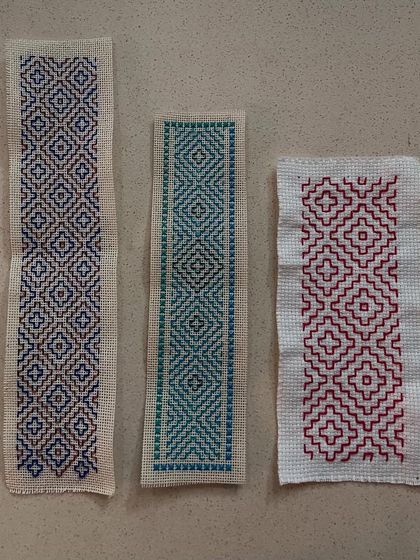 Three bookmarks, one stitch. This image shows how different color combinations and slight pattern variations can create completely different moods and styles using the same fundamental Kasuti technique.