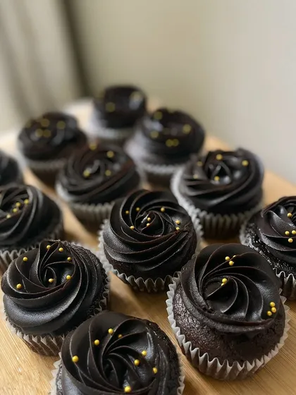 Another look at our rich chocolate cupcakes with gold sprinkles, a classic choice for birthdays and celebrations of all kinds.