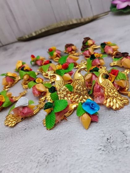 These are small, decorative peacock-themed pieces, perfect for haldi-kumkum ceremonies or as part of a larger gift hamper.