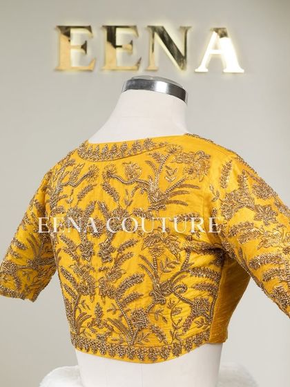This sunshine yellow raw silk blouse is brought to life with meticulous hand embroidery by my talented artisans. The dense, traditional motifs in antique gold threadwork cover the back and sleeves, creating a piece that radiates warmth and luxury.