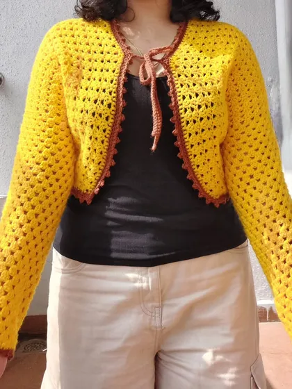 A full-length view of the Odette Cardigan, showing its cropped length and tie-front closure.