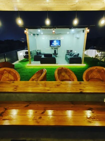 A view from the bar we built, looking towards the cozy glass lounge. We design the entire space to work together, creating different zones for relaxing and socializing.