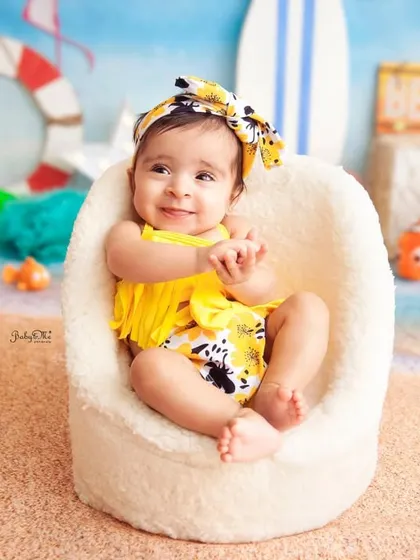 Just chilling at the beach. This little girl's happy smile and bright yellow swimsuit bring so much sunshine to the photo.