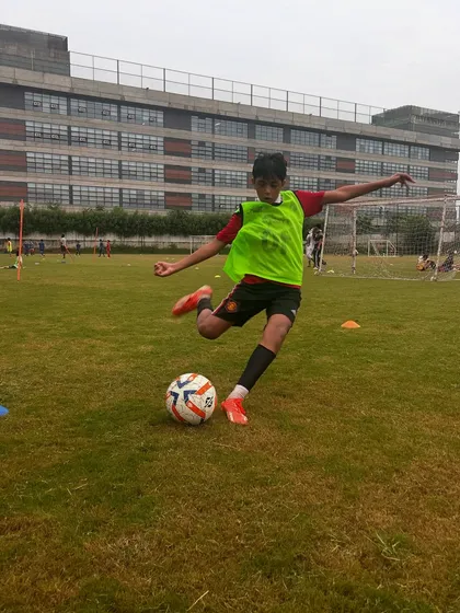 A player mid-strike, demonstrating the kicking technique we teach at the academy.