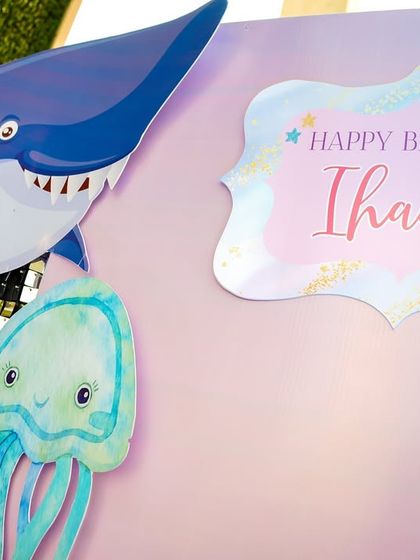 A personalized "Happy Birthday Ihaana" sign with cute sea creatures, showing how I customize every detail to the birthday child.
