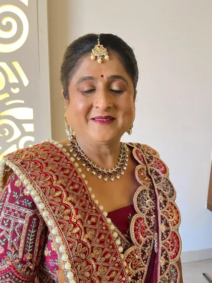 A close-up of another mother-of-the-groom look. The makeup is soft and glowing, with a beautiful berry lip color.