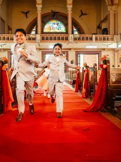 The page boys make a run for it down the church aisle! The pure, uncontainable energy of kids is always a joy to photograph.