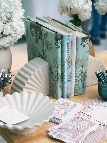 A guest book station at 'The Conservatory' baby shower, with custom-designed stationery and books for guests to leave messages for the parents-to-be.