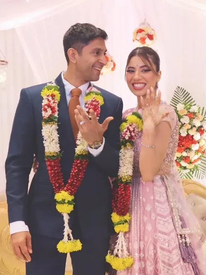 The couple joyfully shows off their rings after the exchange, a classic and essential engagement photo.