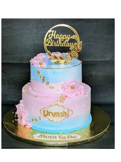 A rustic and elegant two-tier cake for a mom-to-be's birthday. This fresh mixed fruit cake features a simple design with a blend of pink and blue, perfect for a baby shower celebration.